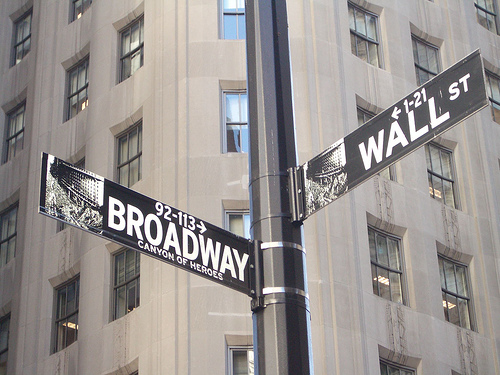 Intersection of Broadway and Wall Street. Why does the Dow keep rising no matter who's in power? Money supply.