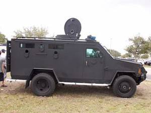 Militarized police vehicle. This kind of display could show the police are soldiers under the Third Amendment.