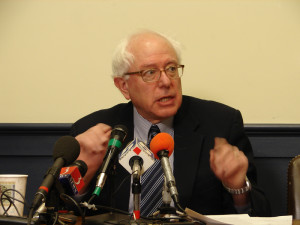 Then-Representative (and Senator-elect) Bernie Sanders (I-Vt.) speaks to the press. Hillary Clinton did not beat Sanders. She rooked Sanders. (S)he who counts the votes...!