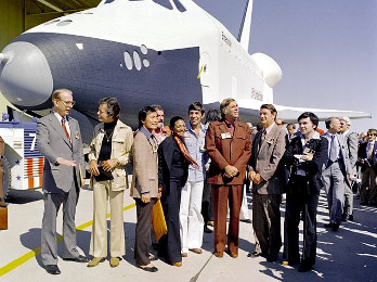 The Star Trek cast and producer pose with a namesake spacecraft.