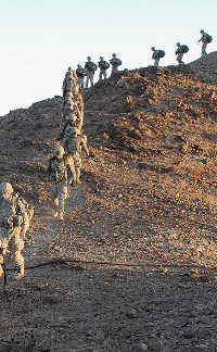 Soldiers on a hill. Real men. The Humanitarian Hoax on the military would make soldiers like these less than combat-ready.