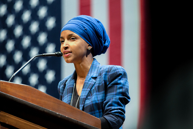 Foreign allegiance: Ilhan Omar wears her Muslim allegiance on her head while campaigning for the U.S. House of Representatives.