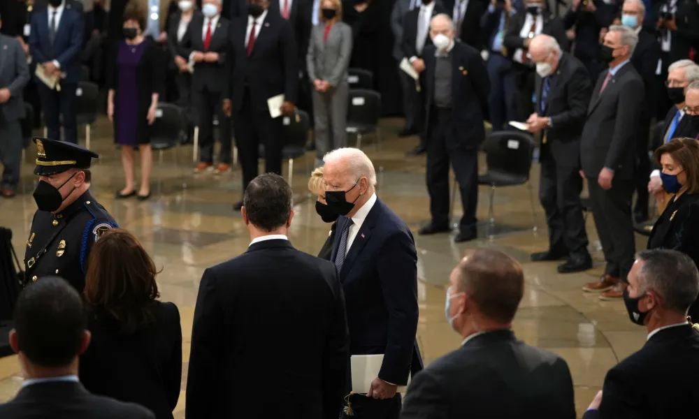 President Joe Biden (foreground, in mask)