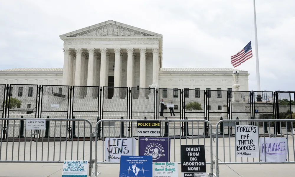 Supreme Court with fences and pro-life bills posted on the bike-rack fence