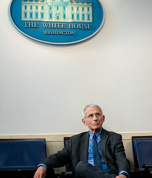 Fauci sits beneath a White House Briefing Room sign.