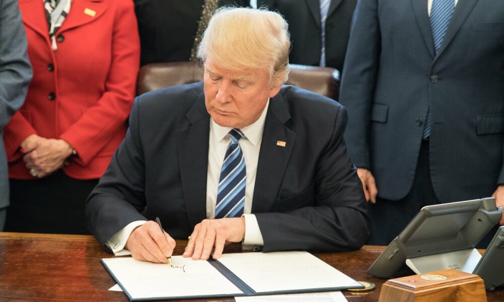 Donald Trump signing a bill