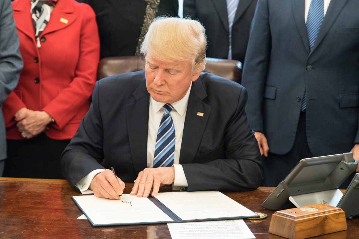 Donald Trump signing a bill