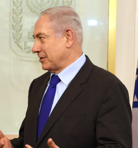 Benjamin Netanyahu with Israeli flag and shield