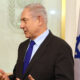 Benjamin Netanyahu with Israeli flag and shield