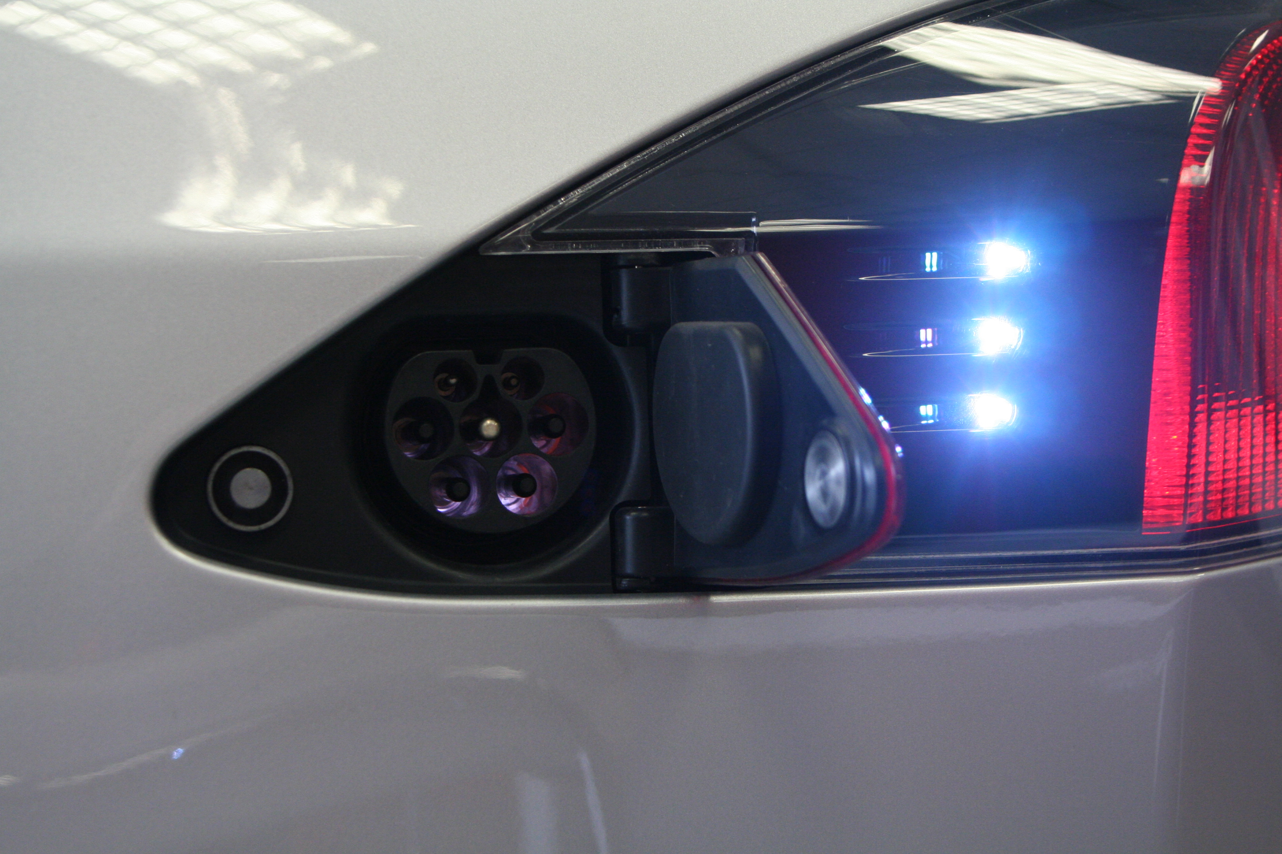An EV charge port with multicolored lights
