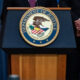 Symbol of the administrative state - Justice Department seal on a bulletproof podium