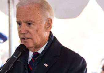 Biden in left profile close-up at microphone