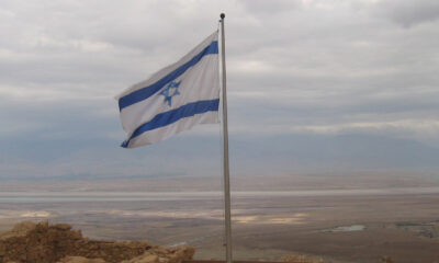 Flag of Israel before a cloudy sky