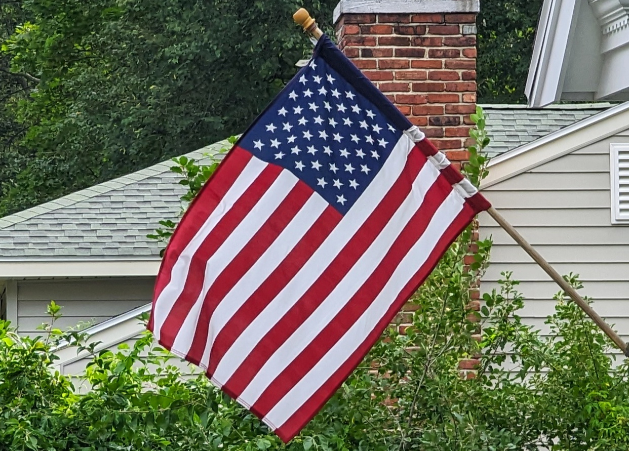 Flag of USA hanging from a single-family house