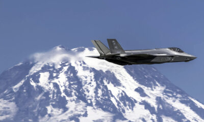 F-35A passing a snow-covered mountain