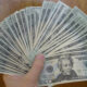 Fan of 20 dollar bills reflecting a debased currency facing entrepreneurs
