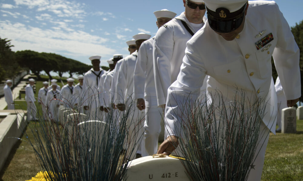 The crew of USS Michael Monsoor DDG 1001 passes in review before the grave of MA2C Michael Monsoor, on the anniversary of his death in action in Iraq