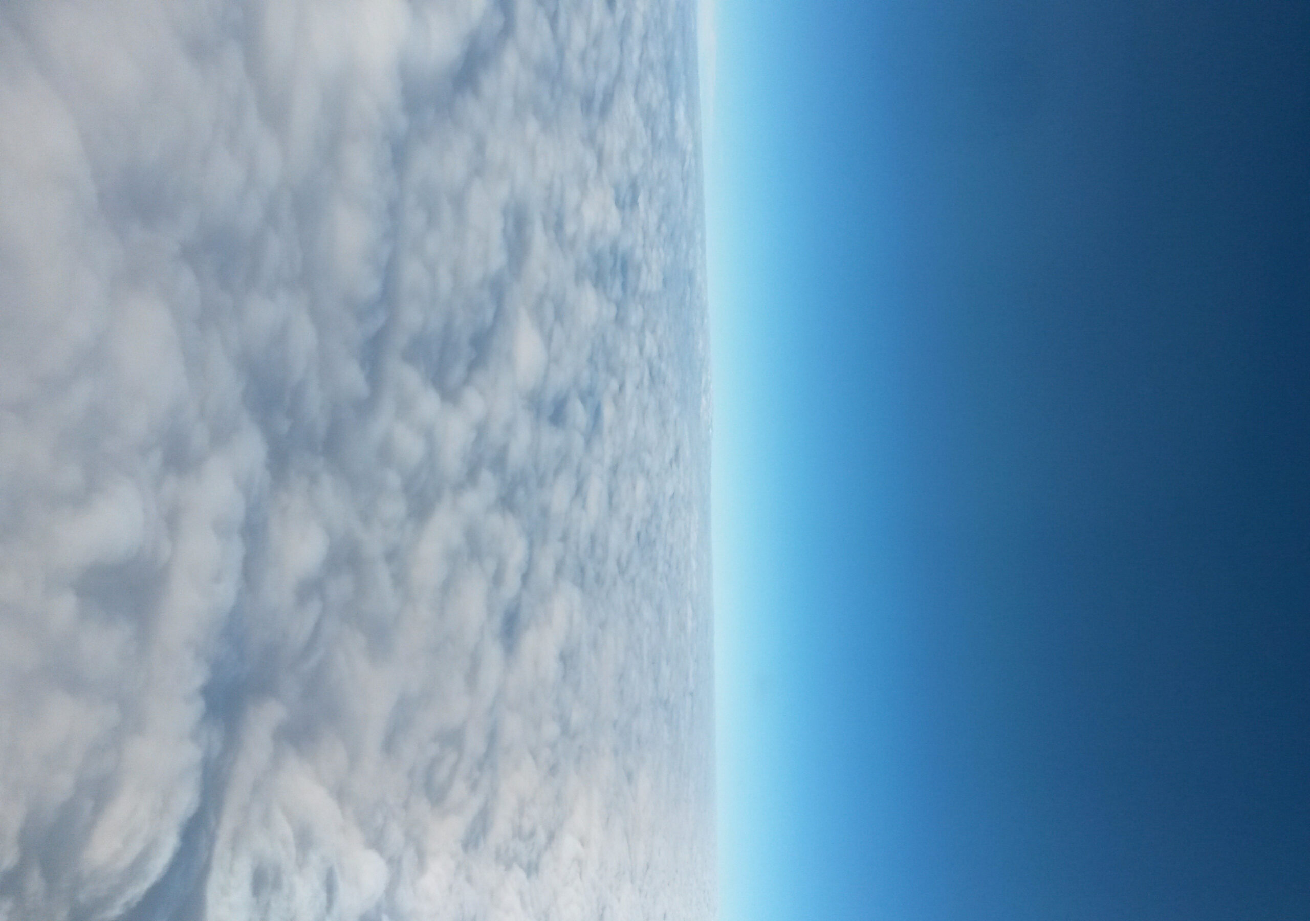 Sky, flying above cirrocumulus cloud bank, rotated 90 degrees clockwise