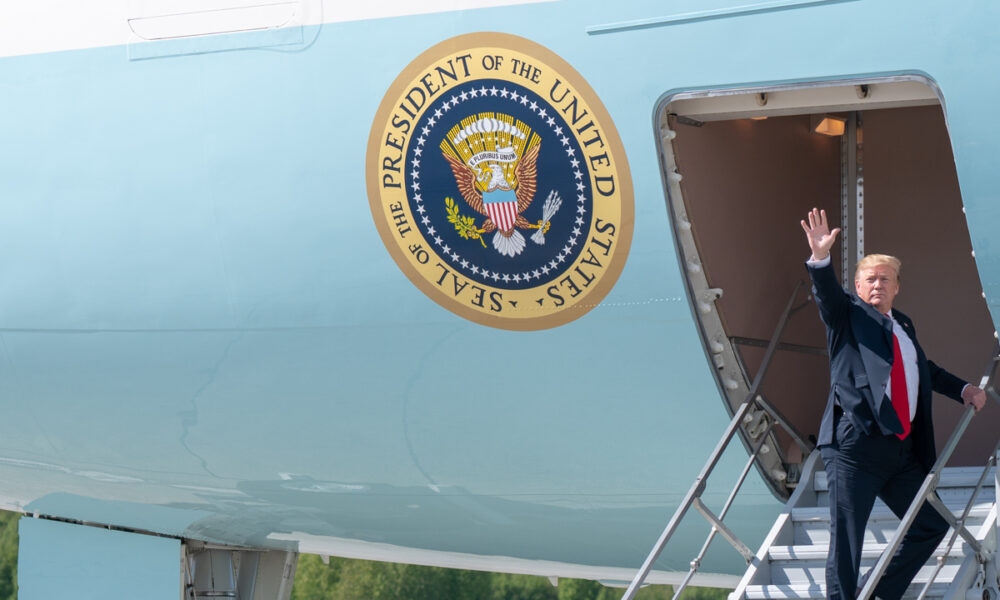 Donald Trump boards Air Force One using the cargo stairs