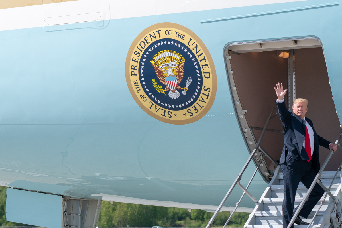 Donald Trump boards Air Force One using the cargo stairs