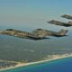 Four F-35 Lightning IIs line up for aerial refueling