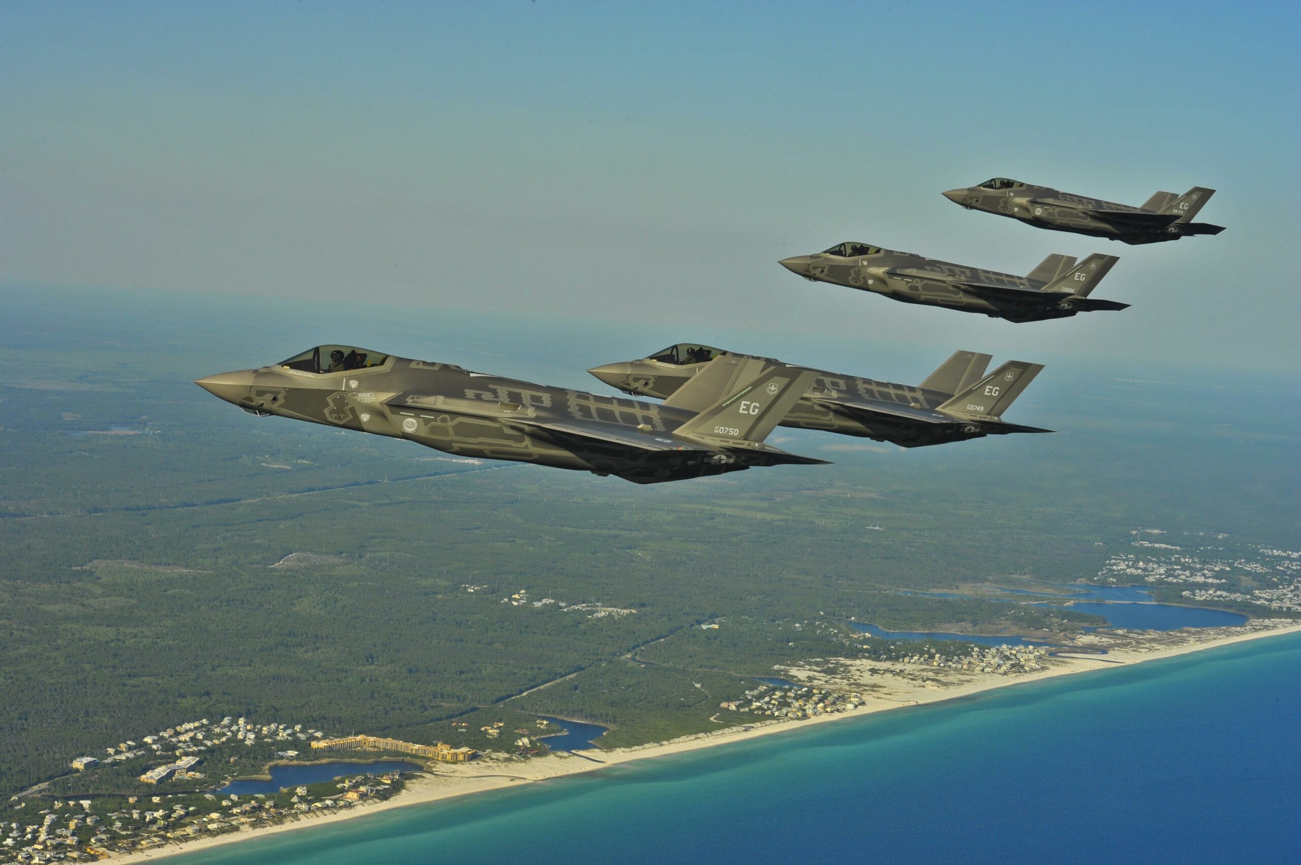 Four F-35 Lightning IIs line up for aerial refueling