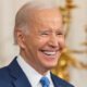 Biden grinning in right-forward-angle close-up