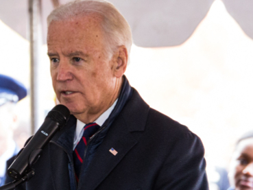 Biden making speech before washed-out white background