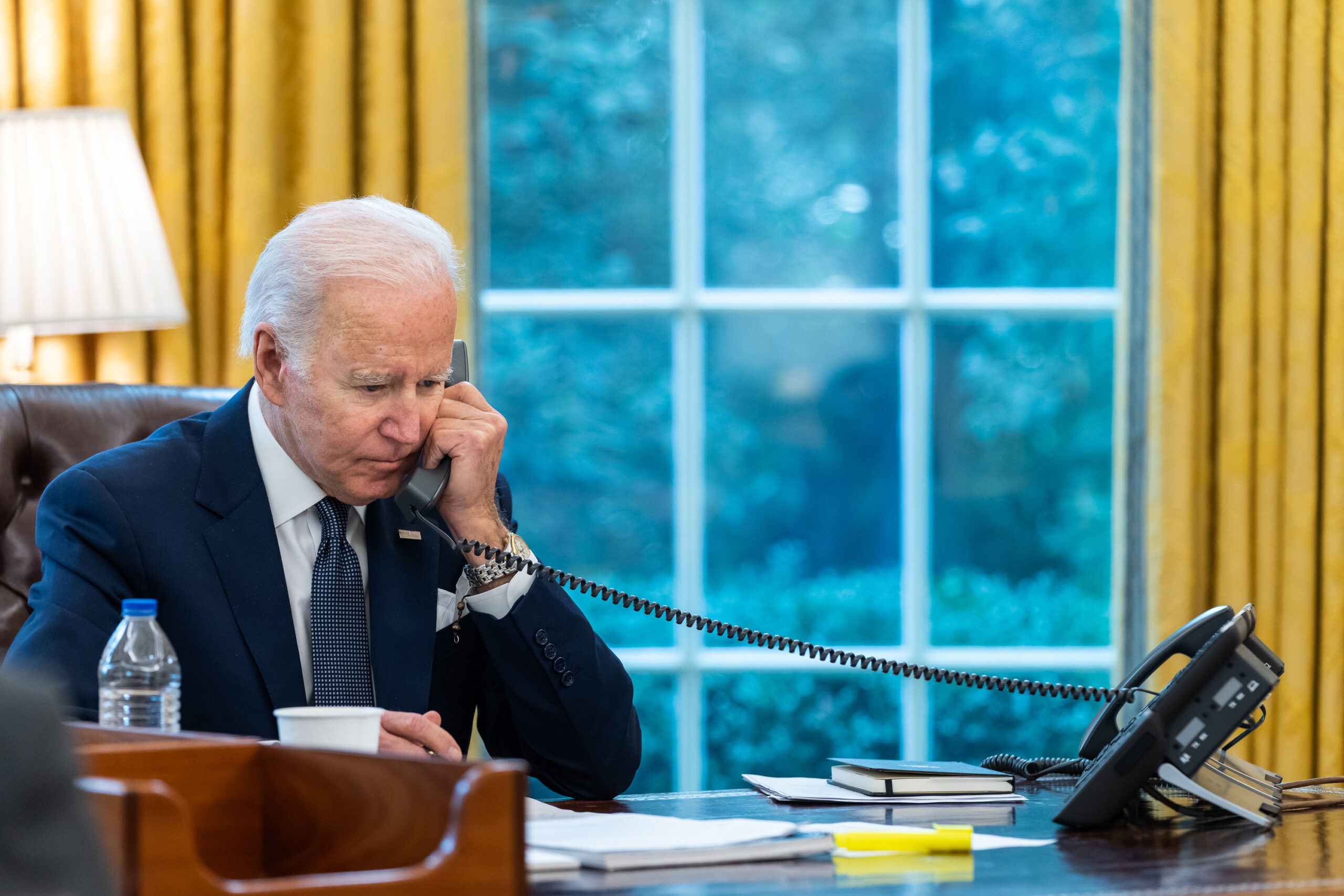 Biden on the telephone in the office with the window