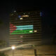 Building lit up and painted in Palestinian flag colors