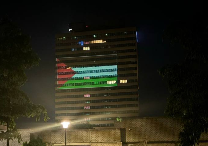Building lit up and painted in Palestinian flag colors