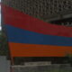 Flag of Armenia in foreground next to building