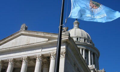 Flag of Oklahoma next to Oklahoma State capitol