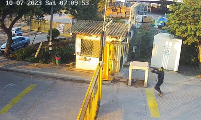HAMAS operative (foreground, at right) shoots through the gate at a kibbutz in the Negev on 7 October 2023.