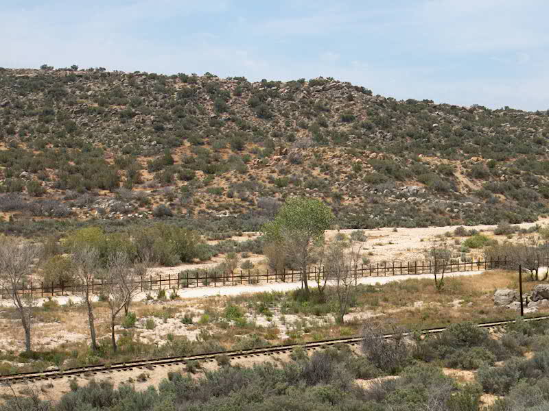 The U.S.-Mexican border, wide-angle with relatively short-standing fence in foreground, prime target for enhanced migration
