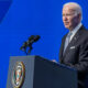 Biden in left profile at podium blue background