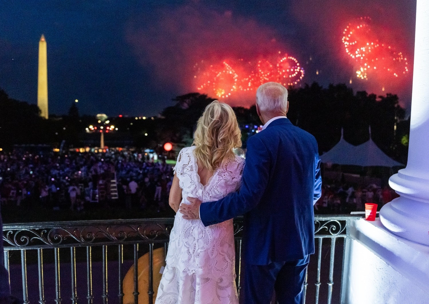 Joe Biden and Jill Biden watch fireworks bursting over the National Mall in Washington, D.C. to right of Washington Monument (view from the White House).