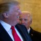Trump, foreground, in right profile, smiles as Joe Biden, to his left, looks on with an angry frown