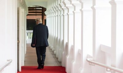 Donald Trup walks past a colonnade