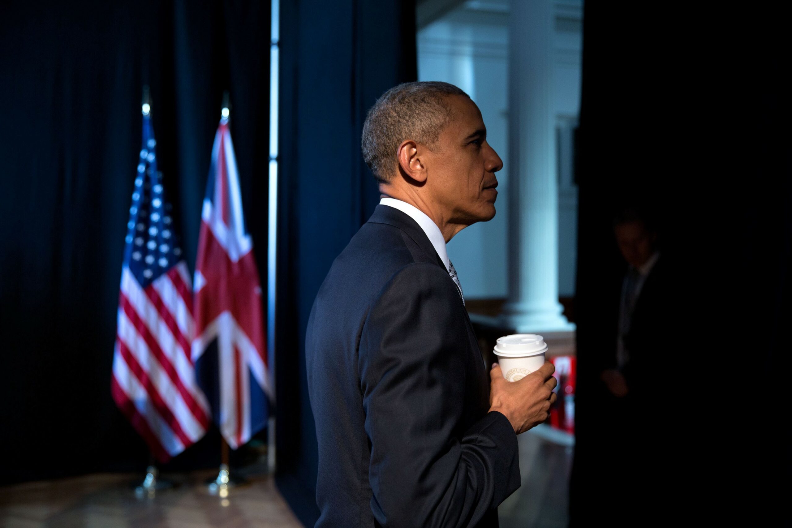 Barack Obama right profile holding a coffee cup