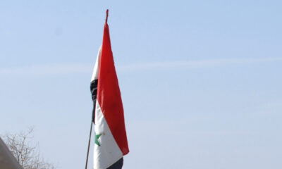 Flag of Iraq in calm sunny sky