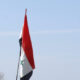 Flag of Iraq in calm sunny sky