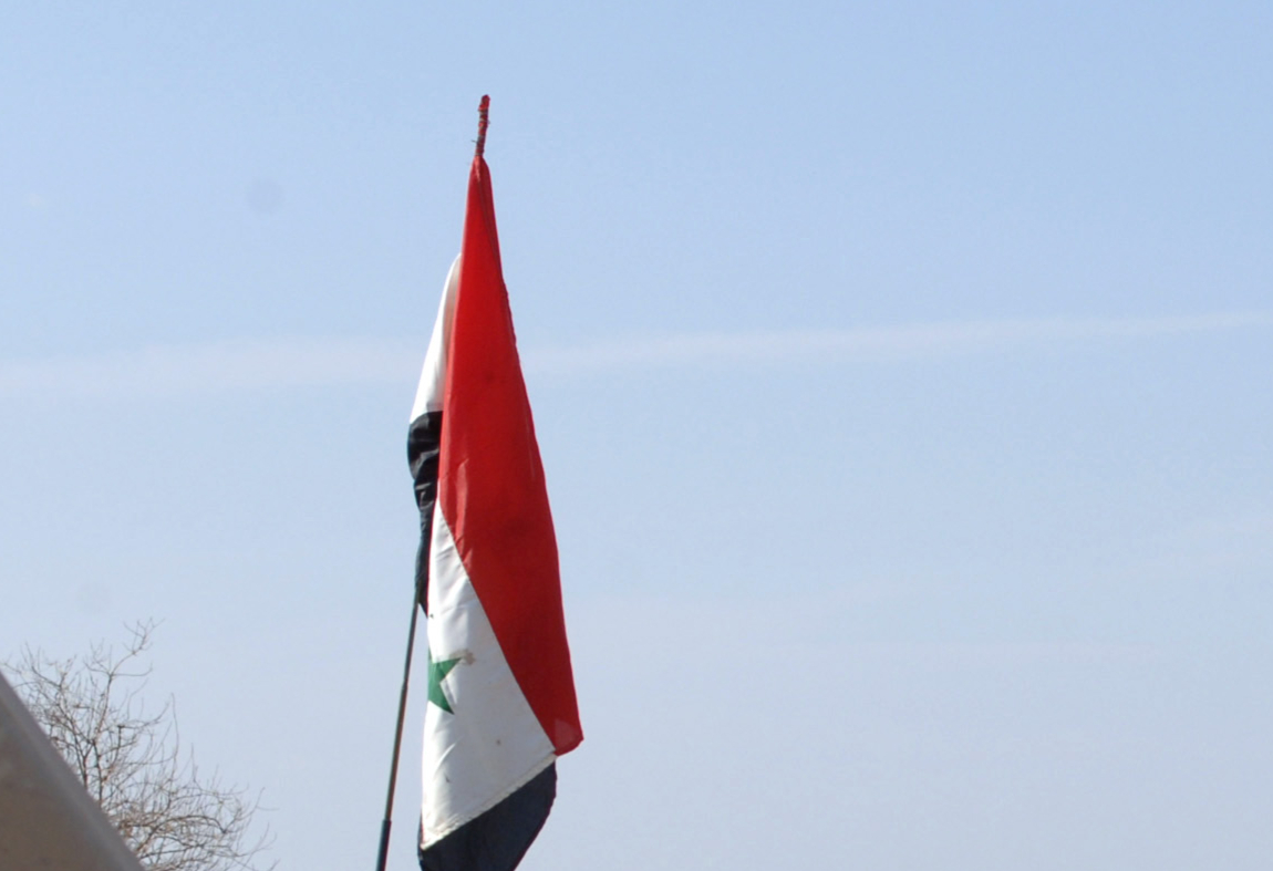 Flag of Iraq in calm sunny sky