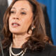 Kamala Harris addressing a meeting at the Justice Department