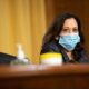 Senator Kamala Harris (D-Calif.) in mask sits at a committee hearing