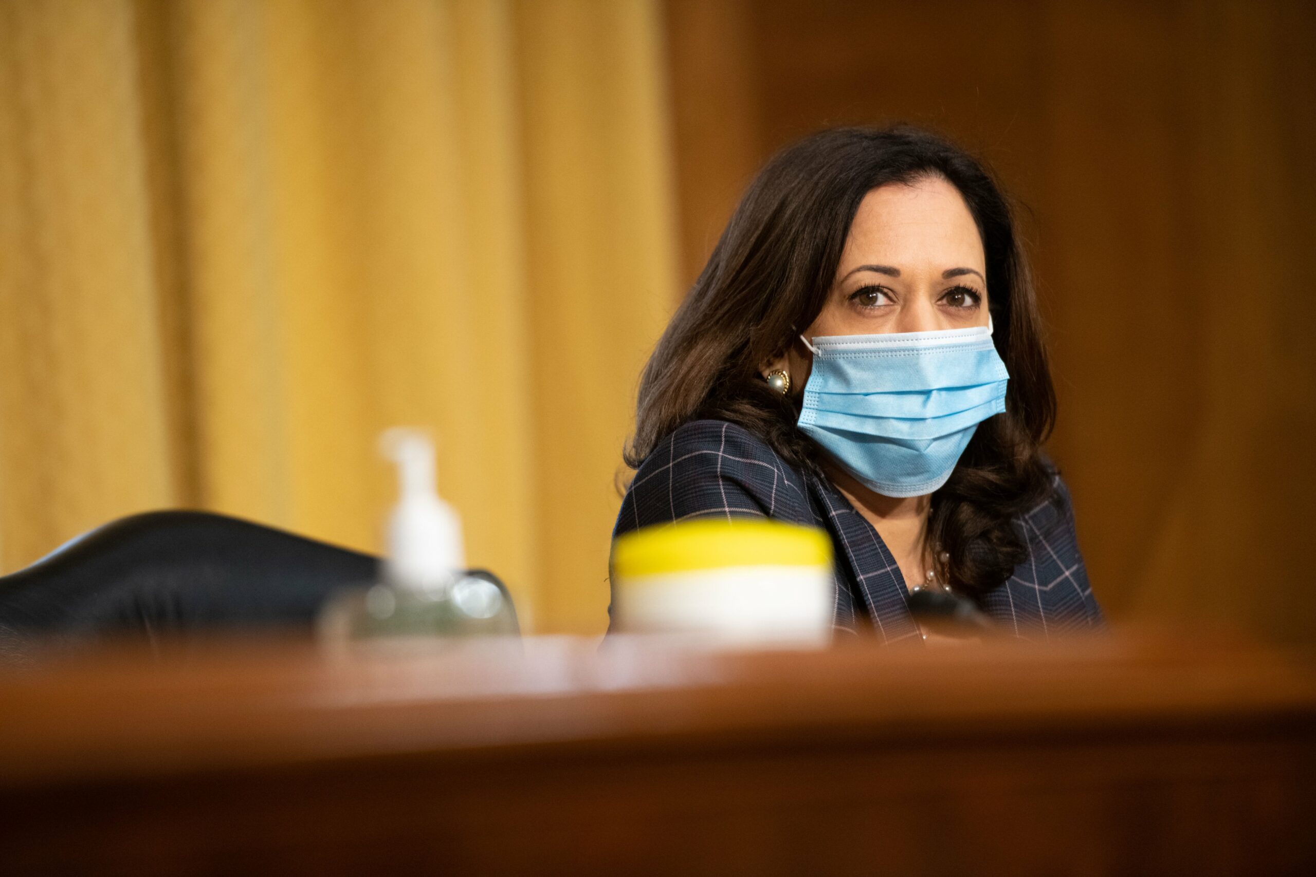 Senator Kamala Harris (D-Calif.) in mask sits at a committee hearing