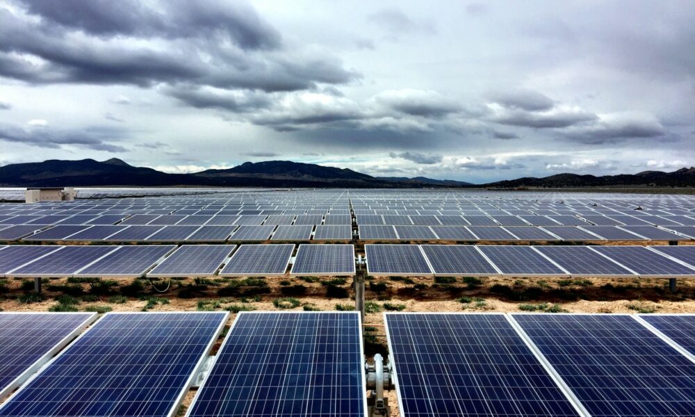 Solar farm under cloudy sky