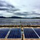 Solar farm under cloudy sky