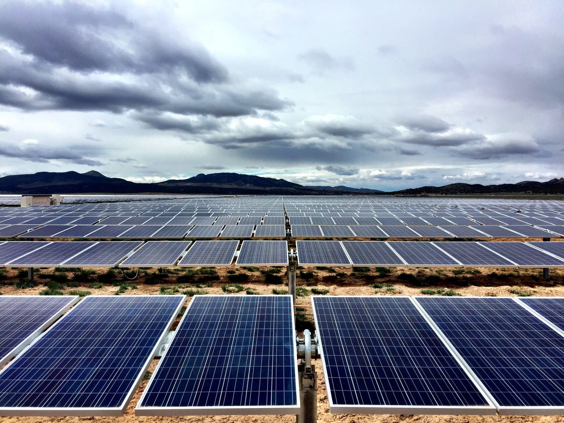 Solar farm under cloudy sky