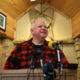 Tim Walz speaks inside a hunting lodge